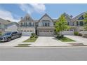Attractive townhome with a two-car garage, neat landscaping, and an inviting facade at 1969 Lanier Harbor Pt, Buford, GA 30518