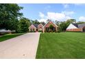 Beautiful brick home with a meticulously landscaped yard, long driveway, and mature trees at 7090 Valley Landing Ct, Cumming, GA 30041