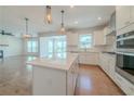 Open kitchen with stainless steel appliances, quartz countertop island, and hardwood flooring at 146 Himalaya Way, Mcdonough, GA 30253