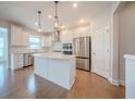 Modern kitchen featuring stainless steel appliances, white cabinets, and a center island at 146 Himalaya Way, Mcdonough, GA 30253