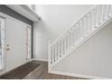 Bright foyer with white staircase, neutral walls, and wood-look flooring by the entry door at 2379 Fallbrook Ct, Duluth, GA 30096