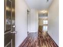 Inviting hallway featuring wood floors that lead into a brightly lit living space at 6470 Saint Mark Way, Fairburn, GA 30213