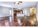 Spacious living room featuring gleaming hardwood floors and an elegant chandelier for a warm ambiance at 6470 Saint Mark Way, Fairburn, GA 30213