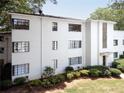 An eye-level view of this white brick complex with black framed windows and a manicured lawn and shrubbery at 1120 Briarcliff Ne Rd # 5, Atlanta, GA 30306