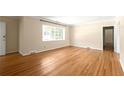 A spacious living room offers hardwood floors, neutral paint, a large window, and traditional trim at 1120 Briarcliff Ne Rd # 5, Atlanta, GA 30306