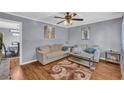 Cozy living room featuring hardwood floors, neutral paint, comfortable couches, and a stylish area rug at 2199 Clairmont Cir, Snellville, GA 30078