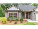 Close-up of the home's entrance, showcasing the brick facade, landscaping, and welcoming front door at 509 Grace Ln, Villa Rica, GA 30180
