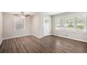 Bright living room with hardwood floors, large windows, and a ceiling fan at 637 Carlouetta Sw Rd, Mableton, GA 30126