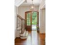 Bright foyer showcasing a staircase, hardwood floors, natural light, and paneled walls at 1016 Old Powers Ferry Rd, Atlanta, GA 30327