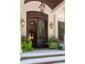 Elegant front entry features a wood door, stone steps and well-manicured landscaping at 1016 Old Powers Ferry Rd, Atlanta, GA 30327