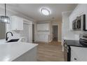 Bright kitchen with white cabinetry, stainless steel appliances, and hardwood floors at 3807 Lance Bluff Ct, Duluth, GA 30097