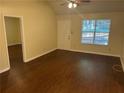 Bright living room with wood floors, large windows, and neutral walls perfect for relaxation at 796 Cohran Store Rd, Douglasville, GA 30134