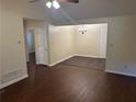 Open living space with wood floors, a ceiling fan, and a dining area with a chandelier at 796 Cohran Store Rd, Douglasville, GA 30134