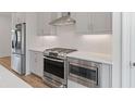 Close-up of a stylish kitchen with stainless steel appliances and sleek countertops at 102 Brackley Dr, Cumming, GA 30040