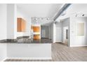 Bright open concept kitchen featuring granite countertops, wood cabinets, and stainless steel sink at 5300 Peachtree Rd # 2309, Chamblee, GA 30341