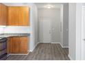 Open-concept kitchen with wood cabinets, granite countertops, and modern appliances at 5300 Peachtree Rd # 2309, Chamblee, GA 30341