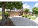 Two-story brick home with a two-car garage and long driveway at 812 Autry Oak Ct, Alpharetta, GA 30022