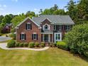 Beautiful brick home with manicured lawn, shrubbery, and classic architectural details at 1552 Brentwood Dr, Marietta, GA 30062