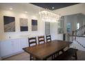 Dining room features a modern chandelier, stylish artwork, and built-in cabinets at 1895 Henley Way, Alpharetta, GA 30009