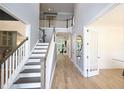 Elegant foyer with hardwood floors, stairs leading to the second floor, and an open floor plan at 1895 Henley Way, Alpharetta, GA 30009