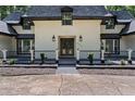 Beautiful home's front entrance with custom double doors, black accents, and manicured landscaping for added charm at 2023 Stoneleigh Dr, Stone Mountain, GA 30087