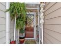 Inviting front entry decorated with seasonal decor and hanging fern at 2404 Fitts Dr, Conyers, GA 30094