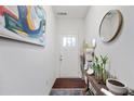 Bright hallway with light walls and a wooden accent table with plants at 2404 Fitts Dr, Conyers, GA 30094