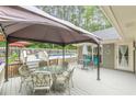 Inviting back deck with shaded seating area, perfect for outdoor dining and relaxing by the pool at 1667 Quail Run, Conyers, GA 30094
