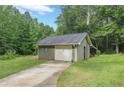 A single-car detached garage offers convenience and storage space within a serene, wooded setting at 1667 Quail Run, Conyers, GA 30094