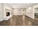 Bright open-concept living space with hardwood floors, a white fireplace, and natural light at 3321 Georgian Woods Cir, Decatur, GA 30034