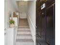 Inviting entryway features a carpeted staircase and a decorative shelving unit at 4254 River Green Dr # 613, Atlanta, GA 30327