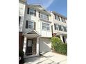 Charming townhouse featuring a brick facade, attached garage, and a welcoming entrance at 6817 Blackstone Pl # 16, Mableton, GA 30126