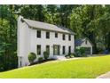 Side view of a two-story home featuring a white brick exterior and a well-maintained lawn at 5236 Forest Brook Pkwy, Marietta, GA 30068