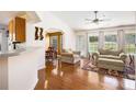 Inviting living room featuring gleaming hardwood floors, a cozy seating arrangement, and natural light at 7057 Silver Bend Ovrlk, Austell, GA 30168