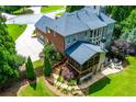 Spacious home featuring an outdoor patio, screened porch, and two-car garage at 141 Olde Heritage Way, Woodstock, GA 30188
