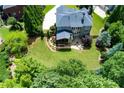 Aerial view of the back of this home showing a well manicured lawn and a screened in porch at 141 Olde Heritage Way, Woodstock, GA 30188