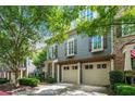 Two-story home with a two-car garage and green landscaping at 2412 St Davids Sq # 16, Kennesaw, GA 30152