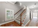 Hallway featuring hardwood floors, a carpeted staircase, and a window at 2412 St Davids Sq # 16, Kennesaw, GA 30152