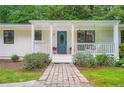 Inviting front porch with a swing, blue front door, and manicured landscaping, perfect for relaxing at 3841 Admiral Dr, Atlanta, GA 30341