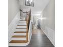 Welcoming entryway with hardwood flooring, a staircase, and decorative lighting fixture at 1804 Evadale Ct # 1, Mableton, GA 30126