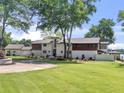 Stately home with expansive front lawn and mature trees on a large lot, showcasing its serene setting at 2775 Club Valley Ct, Jonesboro, GA 30236