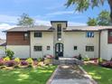 Charming home featuring a manicured lawn, blooming flowers, and a welcoming walkway at 2775 Club Valley Ct, Jonesboro, GA 30236