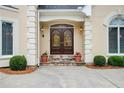 Close-up of the home's double front doors with decorative glass, sidelights and manicured bushes at 2885 Coles Way, Atlanta, GA 30350