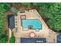 Aerial view of a private pool area with a hot tub, patio, lounge chairs, and manicured landscaping at 2885 Coles Way, Atlanta, GA 30350