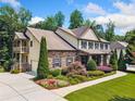 Stunning home with a side-entry garage, lush landscaping, and a charming second-story balcony at 1344 Hamilton Creek Nw Dr, Kennesaw, GA 30152