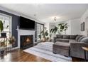 Cozy living room featuring a fireplace, hardwood floors, and lots of natural light at 1452 Crooked Tree Cir, Stone Mountain, GA 30088
