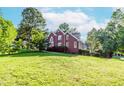 Spacious two-story brick home set on a grassy lot, surrounded by mature trees at 1100 Midland Way, Lawrenceville, GA 30043