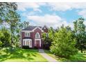 Inviting brick home with a red front door, bay window, and manicured lawn at 1100 Midland Way, Lawrenceville, GA 30043