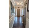 Inviting entryway with hardwood floors, decorative wall accents, and modern lighting at 1581 Shetland Pony Ct, Suwanee, GA 30024