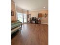 Spacious living room with hardwood floors, large windows, and ample natural light at 1581 Shetland Pony Ct, Suwanee, GA 30024